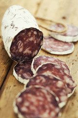traditional sliced meat sausage salami on wooden board