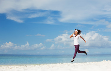 Young woman running on the beach