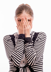 Woman Peaking Through Hands on her face