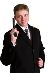 man in a suit aims from a pistol