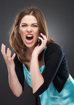 angry woman shouts in phone