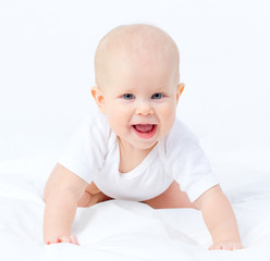 Portrait of a tiny blue eyes baby girl crawling with open mouth
