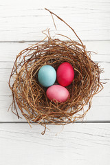 Close-up of  easter eggs on white wooden table