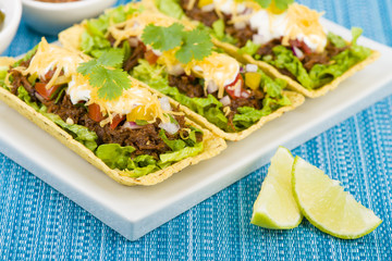 Shredded beef taco trays with salsa, sour cream and cheese
