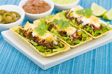 Shredded beef taco trays with salsa, sour cream and cheese