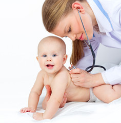 Doctor/ pediatrician with stethoscope listening baby heart