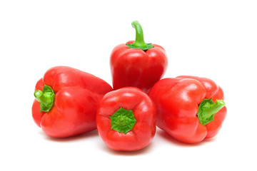 four red pepper close up on white background