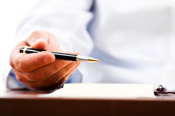 Closeup shot of a doctor writing a medical recipe