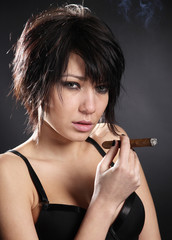 Obraz premium Hot sexy woman with bra smoking cigar