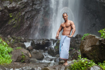 Handsome man at waterfall