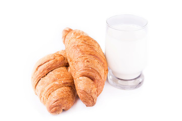 Fresh and tasty French croissants with glass of milk