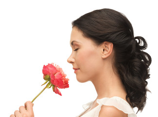 smiling woman smelling flower