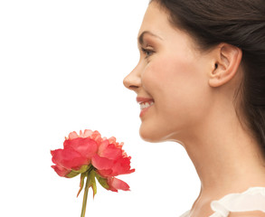 Fototapeta premium smiling woman smelling flower