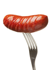 Grilled smoked sausage on a fork
