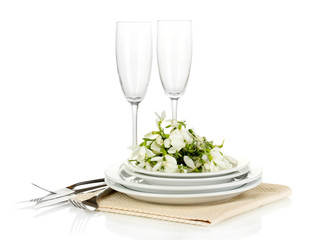 Serving dishes and snowdrops isolated on white