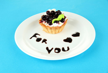 Sweet cake with blackberry and chocolate sauce
