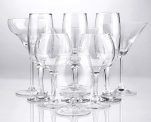 Cocktail and wine glasses, on gray background