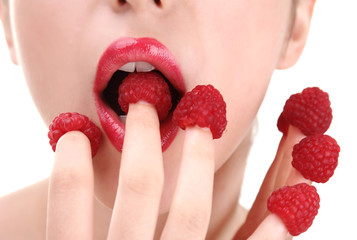 Naklejka premium Sexy diet. Woman eating raspberries from fingers