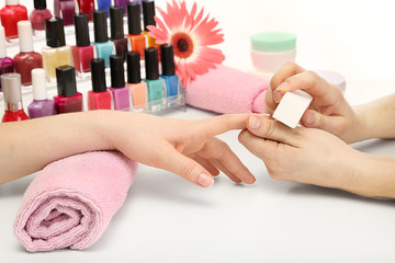 Manicure process in beauty salon, close up