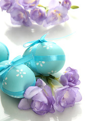 Bright easter eggs with bows and flowers, isolated on white