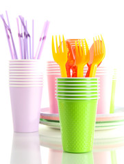 Multicolored plastic tableware isolated on white