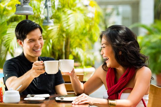 Asian Man And Woman In Restaurant Or Cafe