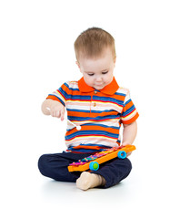 Funny kid playing  with musical toys. Isolated on white backgrou