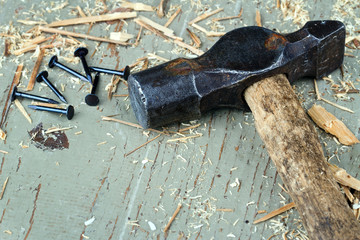 Rustic old hammer on wooden background