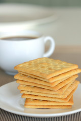 Close-up of cream cracker cookie and hot coffee