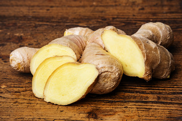 raw ginger on a wooden background