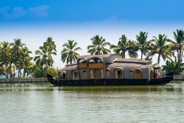 landscape with reflection houseboat in kerala backwaters, India