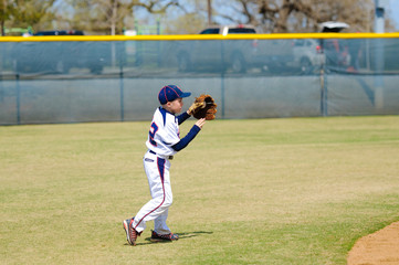 Youth shortstop about to throw ball