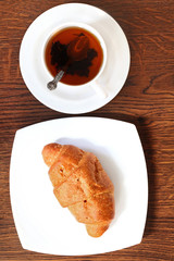 Cup of tea with french croissant