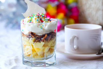 Fruit dessert with colorful sprinkles & cup of tea