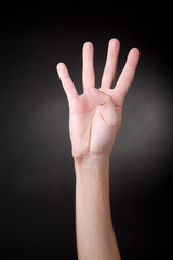 Human hand showing four fingers.