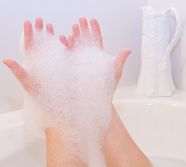 Fototapeta premium Soap foam on hands in bath