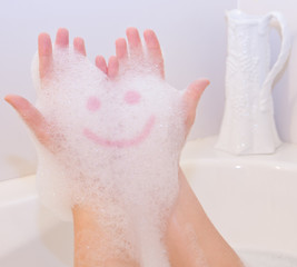 Smile on soap foam on hands