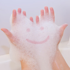 Smile on soap foam on hands
