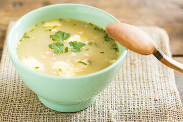 bowl of soup on a vintage table an a wooden spoon