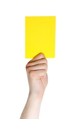 hand holding a yellow card