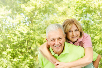 happy senior man giving piggyback ride