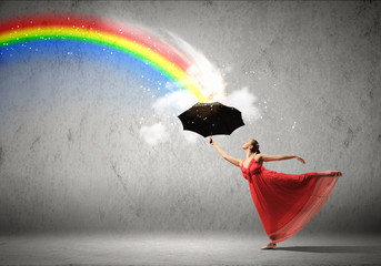Ballet dancer in flying silk dress with umbrella