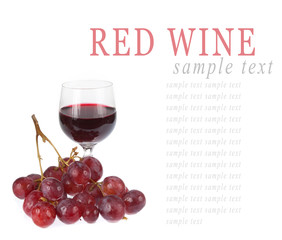 Glass of red wine with grapes isolated on white