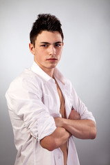 Healthy muscular young man on grey background