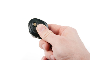 Hand holding remote control (car keys) isolated on white