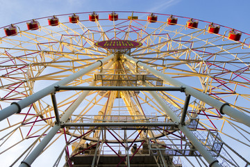 Ferris wheel on blue bright sky