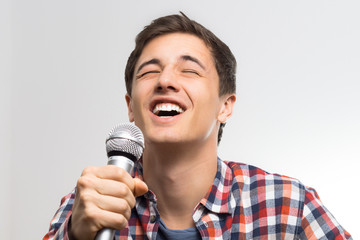 Junger Mann singt ins Mikrofon