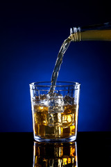 Small glass of poured alcohol.