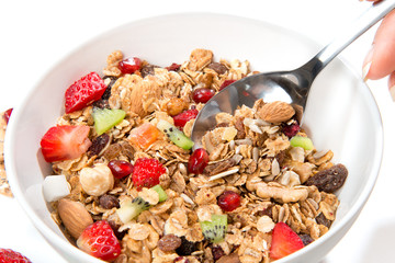 Muesli cereals bowl and spoon with almond, pine nuts
