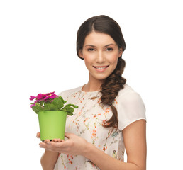 lovely housewife with flower in pot